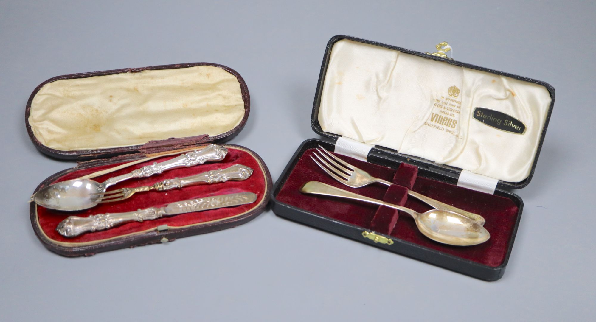 A cased Victorian silver christening trio (plated fork tines replacement), box a.f and a later cased silver christening pair.